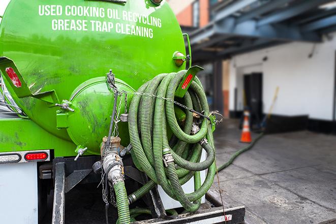 a vacuum truck pumping out a large underground grease trap in Laguna Beach CA